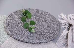 Detail of woven cotton table mats in grey and green with natural minimalist textures