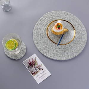 Macro view of light blue woven cotton placemat set for heat-insulated dining table decor