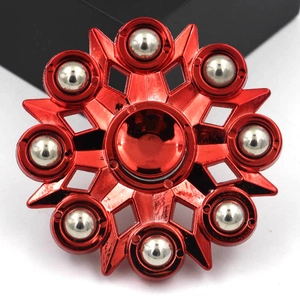 Macro detail of red octagonal fidget spinner toy with eight embedded silver metal balls