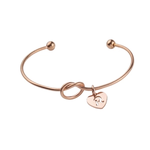 Rose gold knotted open bangle with heart charm featuring letter R pendant
