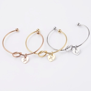 Three-piece stainless steel knot cuff bracelets with heart letter pendants in trio tones