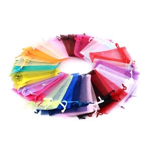 Colorful organza gift bags with drawstring closure arranged in a circular palette