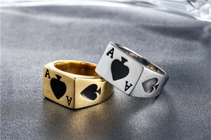 Detailed view of silver and gold punk rings featuring Ace of Spades poker engraving