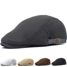 Detail of breathable mesh texture and adjustable metal buckle on dark gray beret