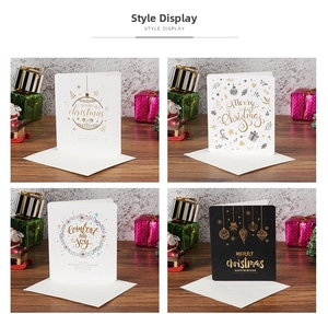Detail showing four Christmas greeting card designs with gold foil accents and envelopes