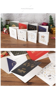 Detailed view of assorted Christmas cards with gold foil stamping and matching envelopes