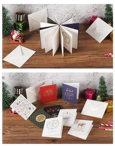 Detailed view of assorted gold-stamped Christmas cards on a wooden festive background