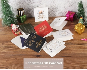 Detailed view of 3D Christmas greeting cards with gold foil elk and ornament designs