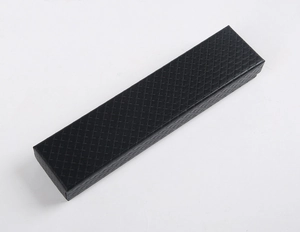 Macro detail of black rectangular gift box featuring an elegant diamond texture surface