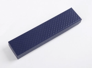 Macro view of long rectangular dark blue jewelry box with textured diamond pattern