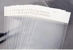 Detailed view of clear jewelry packaging bags with white fashion jewellery header cards