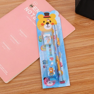 Five-piece creative stationery set for children with cute bear patterns on a wooden desk