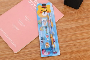 Detailed blue cartoon bear stationery set with pencils, ruler and eraser on wood table