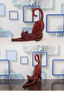 Detail of creative resin cat sculpture showing glossy dark reddish-brown finish and smooth lines
