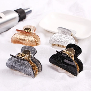 Detailed set of four glitter hair claws in gold, silver, grey, and black colors