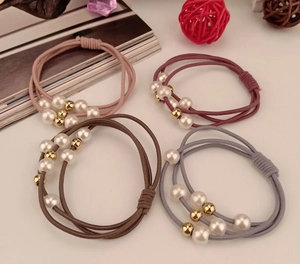 Close-up of three-strand elastic hair ties with faux pearls and golden beads set of four