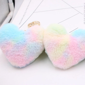 Rainbow gradient faux fur heart keychain with gold metal ring on a white surface
