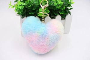 Detail of colorful rainbow faux fur heart keychain with golden metal ring and chain link