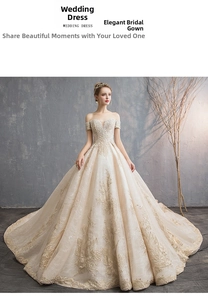 Detailed view of champagne bridal gown with gold floral embroidery and shimmering sequins