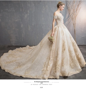 Detailed embroidery with gold patterns and pearl beads on off-shoulder bridal gown