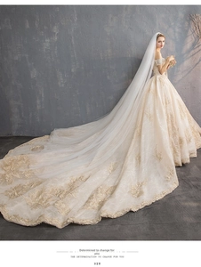 Detailed back view of off-shoulder wedding gown with long embroidered train