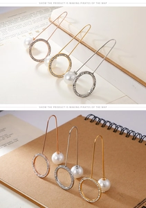 Detail of long U-shaped earrings with rhinestone circles and pearls in three plating colors