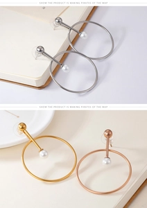 Detailed view of minimalist hoop earrings with pearls in gold, silver, and rose gold
