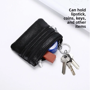Black pebbled leather pouch showing storage for lipstick, keys, and coins in three pockets
