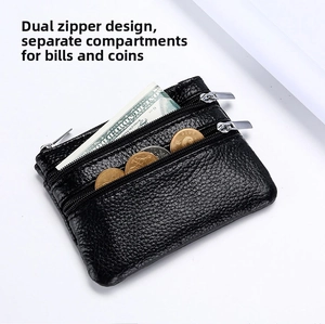 Detail of black pebbled leather coin purse featuring dual zipper pockets and multi-slots