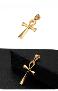 Macro view of polished golden stainless steel Egyptian Ankh cross pendant for men