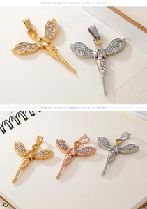 Detailed view of angel wing pendants in gold, silver, and rose gold with zircon stones