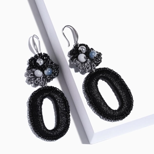 Handmade black woven hollow oval bohemian earrings with bead accents and silver hooks