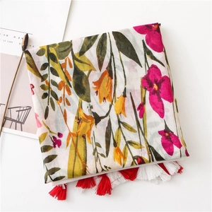 Detail of floral cotton linen scarf with vintage lily prints and handmade tassels