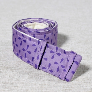 Macro shot of purple fabric bake even strips for cake pans on linen background