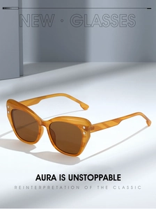 Detail of amber cat-eye sunglasses featuring high-quality frames and metal temples