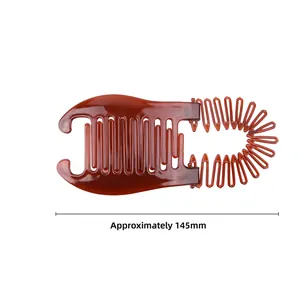 Detailed macro view showing a 145mm amber plastic banana hair clip with wavy comb teeth