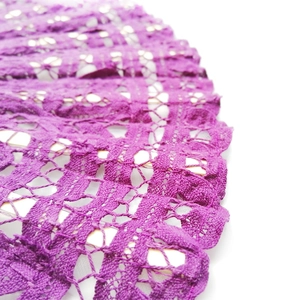 Detailed macro view of purple lace folding fan with intricate floral patterns and textures