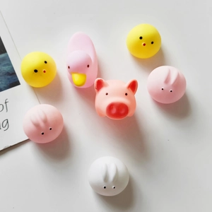 Flat lay of colorful soft rubber squeeze toys featuring cute pig, duck, and chick designs