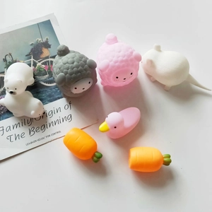 Close-up of cute pink pig and animal squishy toys on a white background with a postcard