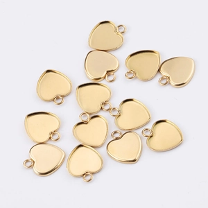 Macro detail of heart-shaped gold plated stainless steel pendants for DIY jewelry making