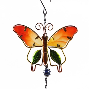 Detailed close-up of a colorful metal and stained glass butterfly wind chime ornament