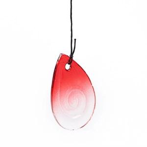 Macro view of teardrop glass pendant with red swirl patterns and creative metal hook