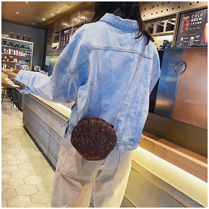 Chic round sequin crossbody bag with silver chain and pearl zipper detail shown on model