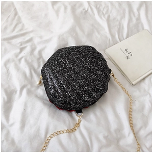 Top-down view of black glitter shell crossbody bag with gold chain and pearl zipper