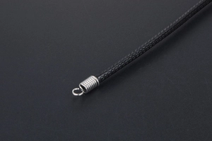 Close-up of black braided cord necklace with silver metal spiral spring clasp detail
