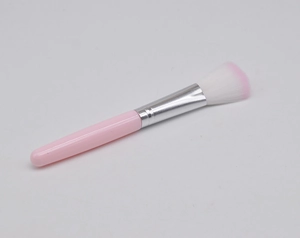 Detail of soft pink blush brush with silver ferrule and two-tone synthetic bristles