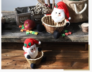 A decorative set of two Santa Claus themed woven candy baskets in a festive lifestyle scene