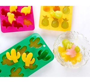 Detail of cactus, pineapple, and penguin shaped silicone ice molds with fruit ice