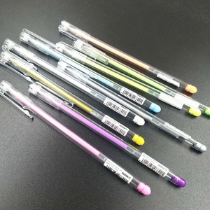 Set of 8 colorful high gloss pastel pens with transparent barrels on dark background