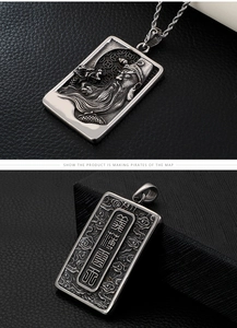 Macro view of vintage silver Guan Yu pendant with intricate relief and engraved back